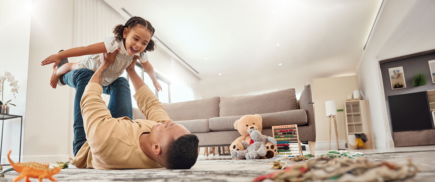 father playing with toddler daughter